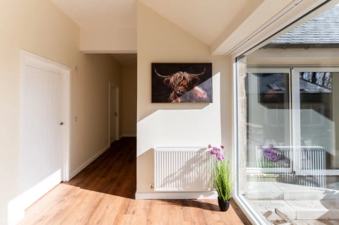 Hallway with Highland cow print and picture window