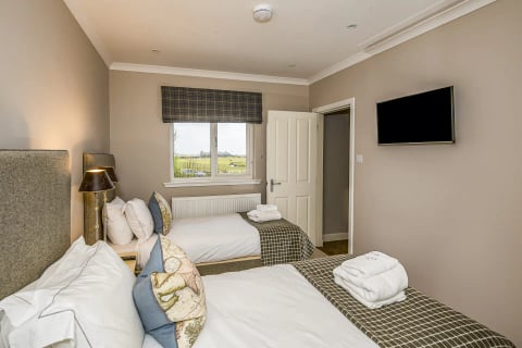 Twin bedroom with TV and views towards the links