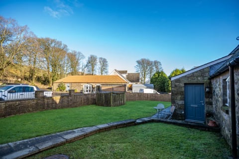 Back garden with terraced lawn and patio
