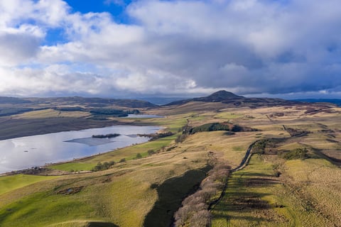 Aerial view towards the loch and hills beyond