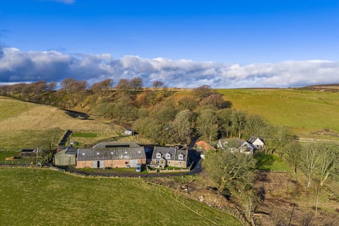Aerial view of the farm steading among the trees