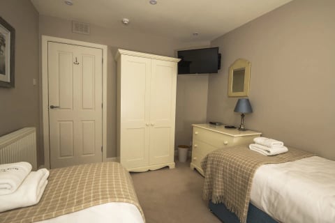 Bedroom with cream wardrobes and mirror