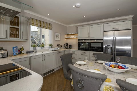 Fitted kitchen with breakfast table and coffee station