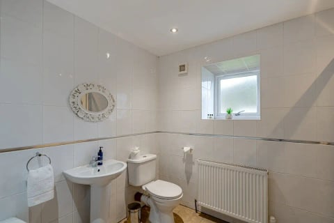 White bathroom with basin, WC and frosted window