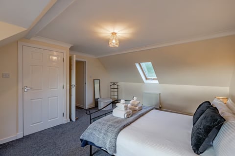 Attic bedroom with skylight and clothes rail