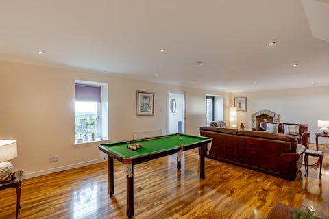 Games area with pool table by the window