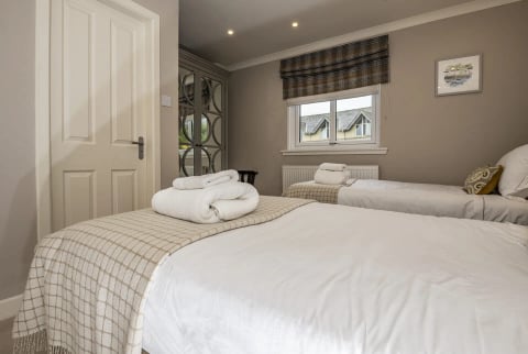 Double bedroom with tartan roman blind