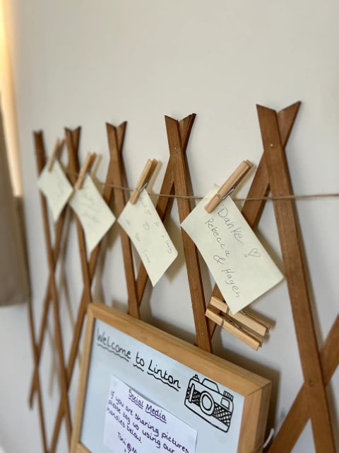 Welcome board with guest notes pegged on twine