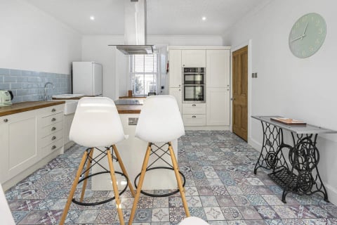 Kitchen with island stools and built-in ovens