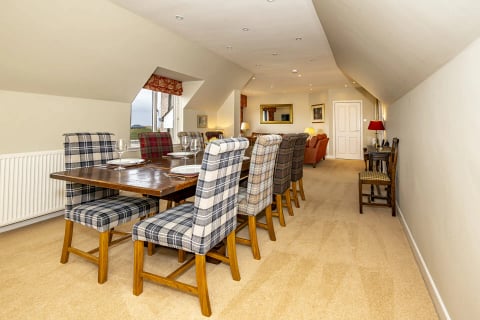 Dining table with tartan chairs seating eight