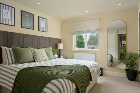 King bedroom with green striped runner and mirror
