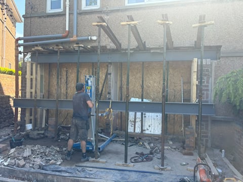 Steel beams and props in place as a rear extension takes shape