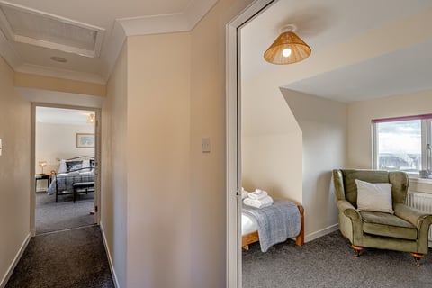 Landing into the twin bedroom with wicker light shade