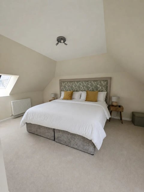 Eaves bedroom with mustard cushions