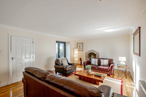 Leather three-piece suite around the fireplace