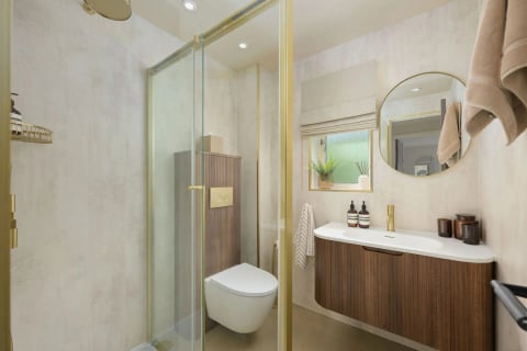 Walk-in shower with gold trim and floating vanity