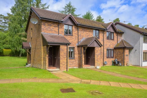 The pair of brick cottages across the lawn