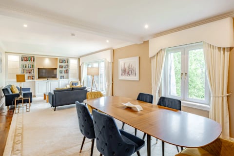 Open-plan dining and lounge with navy chairs