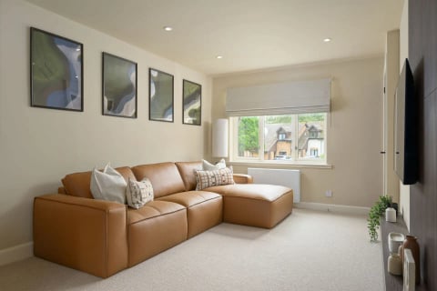 Tan leather corner sofa with cream cushions