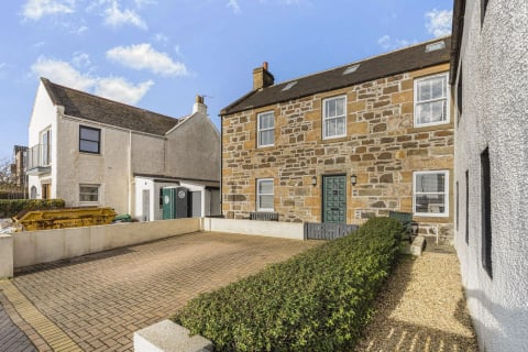 The stone house with dormers and courtyard