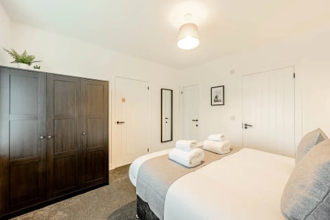 Bedroom with dark built-in wardrobes