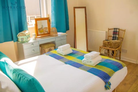 Bedroom with dressing table, mirror and Highland blanket
