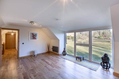 Bedroom with picture windows onto the fields