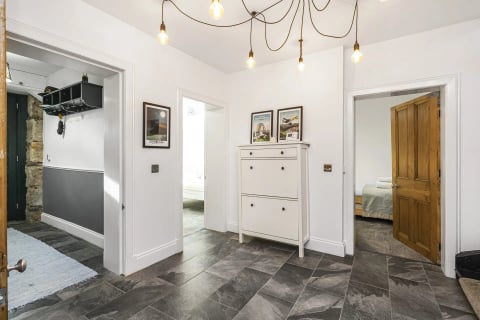 Hallway with statement pendant and shoe cabinet
