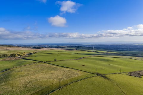 Rolling farmland stretching to the Firth of Forth