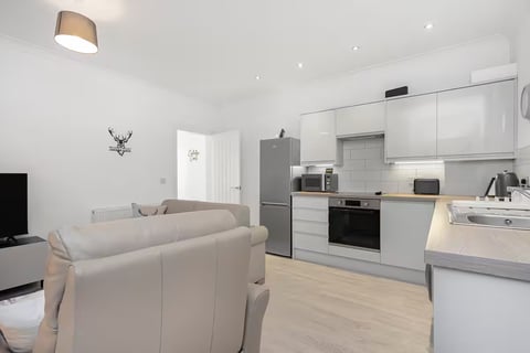 Studio living area with kitchen and washer-dryer