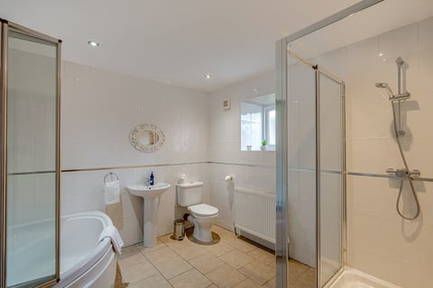 Bathroom with corner bath and separate shower