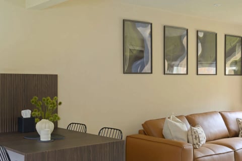Desk corner with abstract artwork above