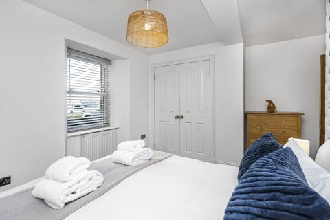 Bedroom with cupboard and rattan pendant