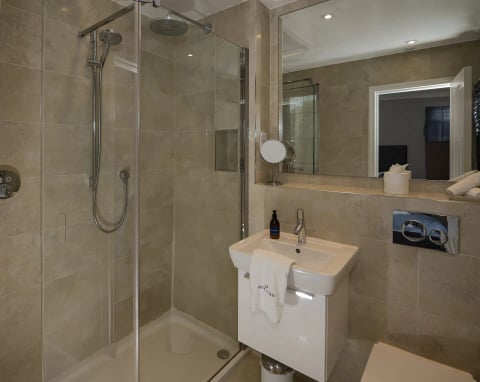 Walk-in shower room with glass enclosure