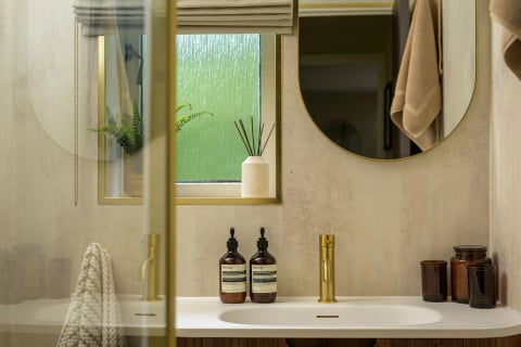 Vanity with rain-glass window and gold tap