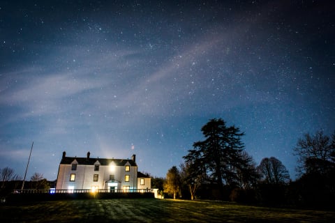Carphin House beneath a starry night sky