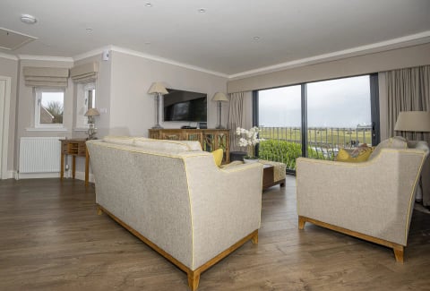 Living room with TV and picture window onto the links