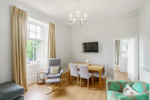 Dining area with TV and armchairs