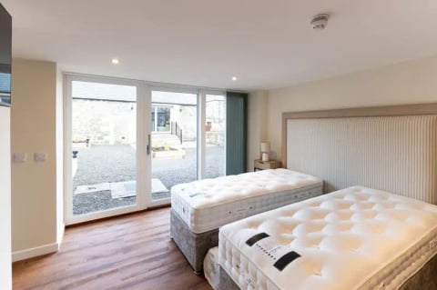 New mattresses arriving in the bright bedroom