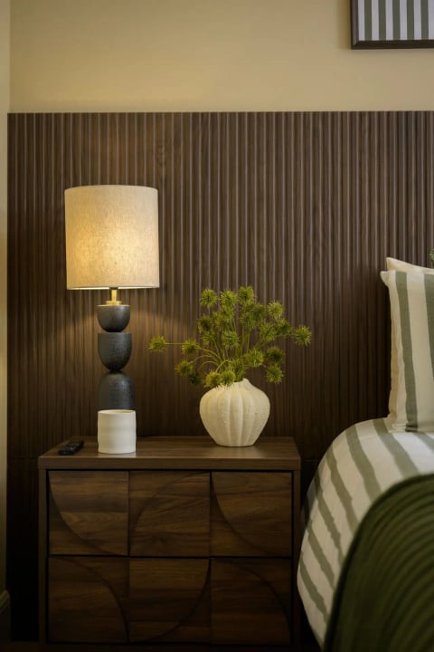 Guest bedroom corner with warm lamplight