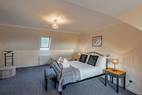 Double bedroom in the attic with iron bedstead