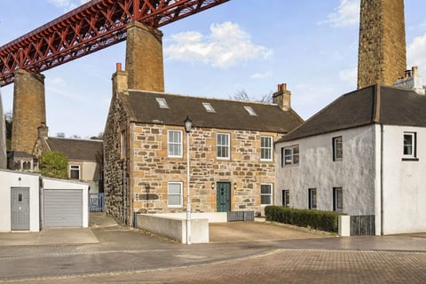 The Old Jail - stone house beneath the Forth Bridge chimney-side