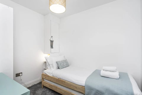 Single bed with wicker pendant light