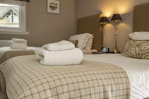 Fresh towels laid out on the bed in the master bedroom