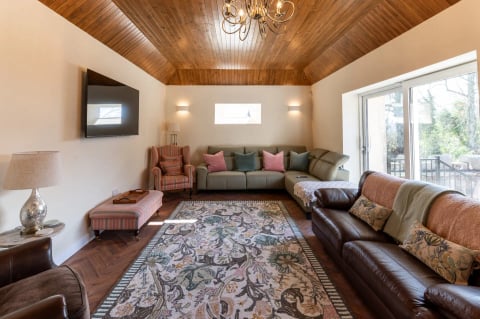 Huge timber-ceilinged lounge with wrap-around sofas