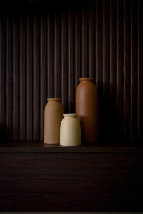 Earthenware vases against the dark panelling