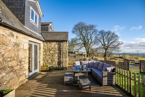 Deck seating beside the stone extension