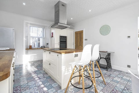 Kitchen with induction island and tiled floor