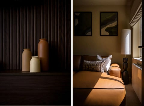 Vases on the dark dresser beside the leather sofa