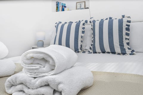 Striped cushions and towels on the guest bed
